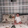 animal_print, baby, bed, bedding, child, deer, fabric, happy, indoor, newborn, owl, person, photo_frame, pillow, plaid_wallpaper, portrait, smiling, squirrel, tree, woman