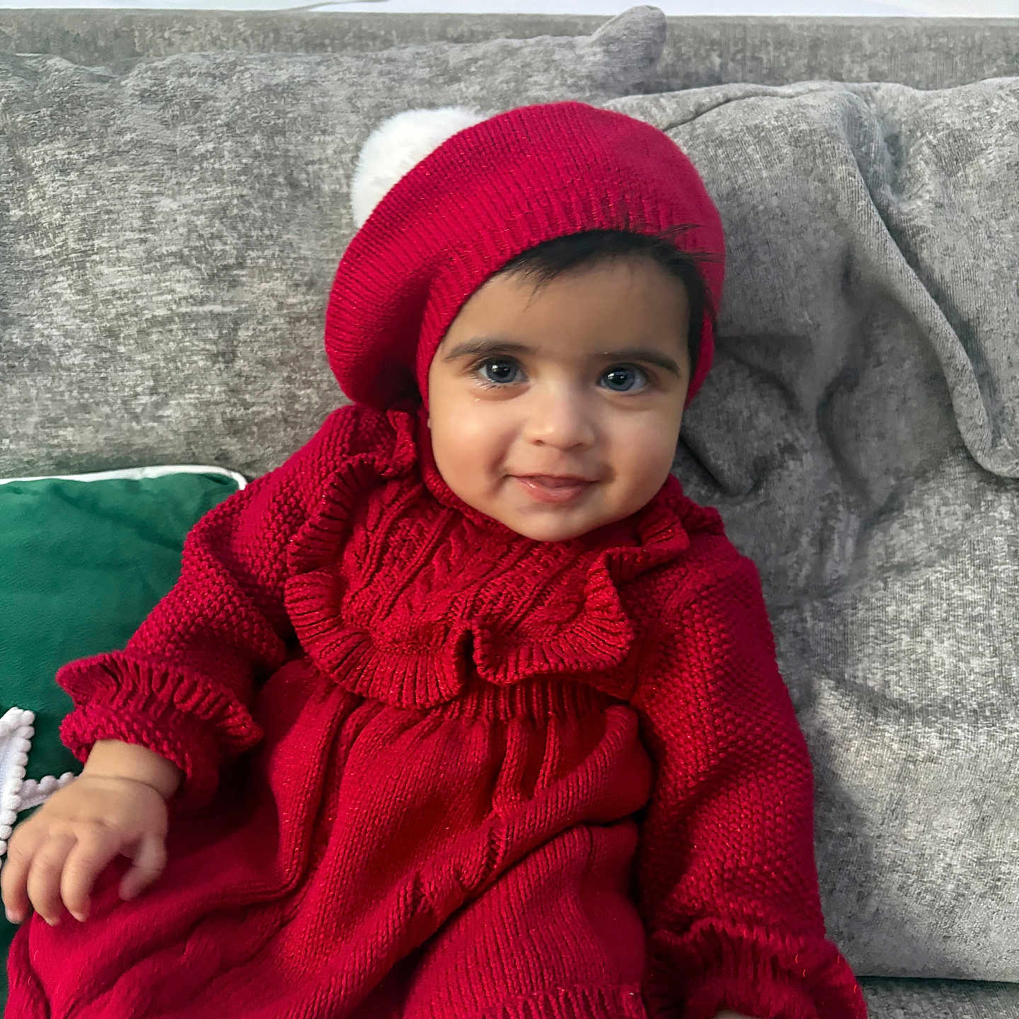 Khalila-Zaya joined the competition — help win amazing prizes! baby, child, couch, cozy, cushion, cute, face, fashion, hand, happy, headwear, indoor, knitwear, person, portrait, red_beret, red_dress, seated, smile, young_child