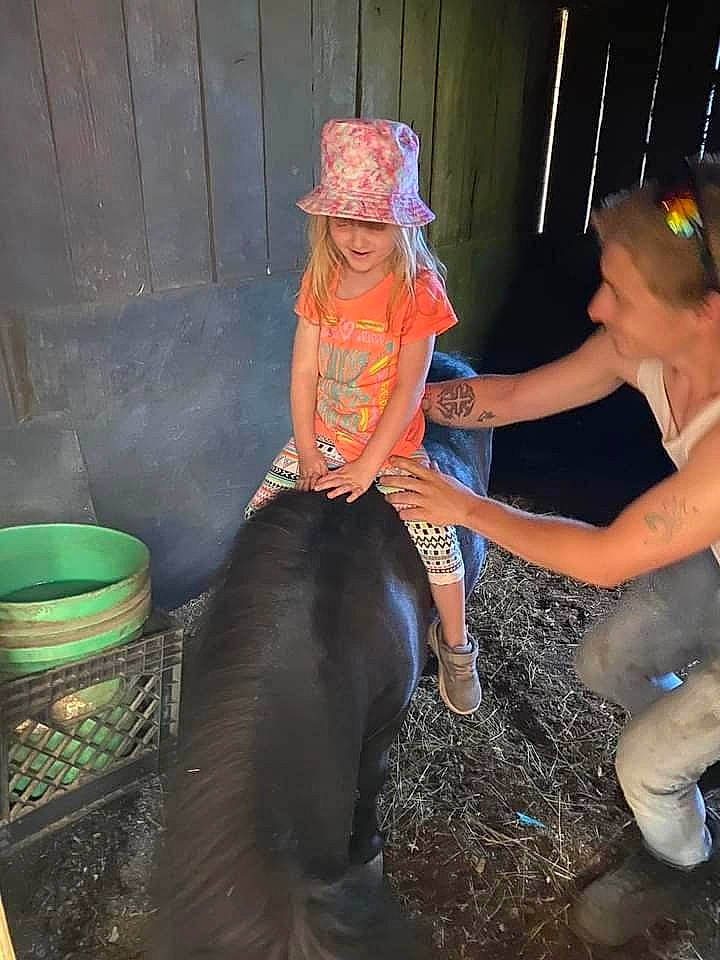 Raylynn is registered to the contest to win money with this photo: baseball_cap, boot, cap, entertainment, event, fashion_accessory, flash_photography, fun, hat, headwear, human_leg, joy, knee, leg, leisure, magenta, midnight, person, sitting, smile