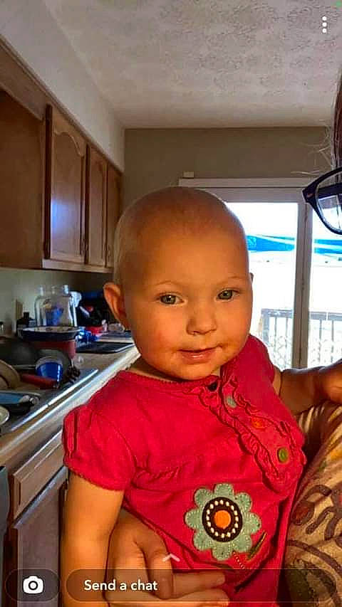 Jordyn is registered to the contest to win money with this photo: cabinetry, child, chin, cooktop, countertop, eye, eyelash, fun, gas_stove, hairstyle, happy, head, home_appliance, iris, kitchen, kitchen_appliance, kitchen_stove, person, smile, t_shirt