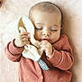 baby, sleeping, onesie, clothing, blanket, soft_toy, hand, face, infant, peaceful, cute, closeup, portrait, child, cozy, indoor, toddler, fabric, relaxation, comfort
