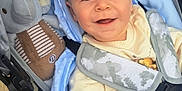 Arran is registered to the contest to win money with this photo: baby, blanket, blue_eyes, casual, clothing, comfort, elephant_toy, face, foot, footwear, hand, infant, joy, outdoor, pavement, person, plush_toy, smile, straps, stroller