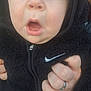 Arran is registered to the contest to win money with this photo: baby, black_clothing, blue_eyes, casual_clothing, child, closeup, curious, expression, face, fuzzy_texture, hand, holding, hoodie, nike_logo, outdoor, person, portrait, skin, young_child, zipper