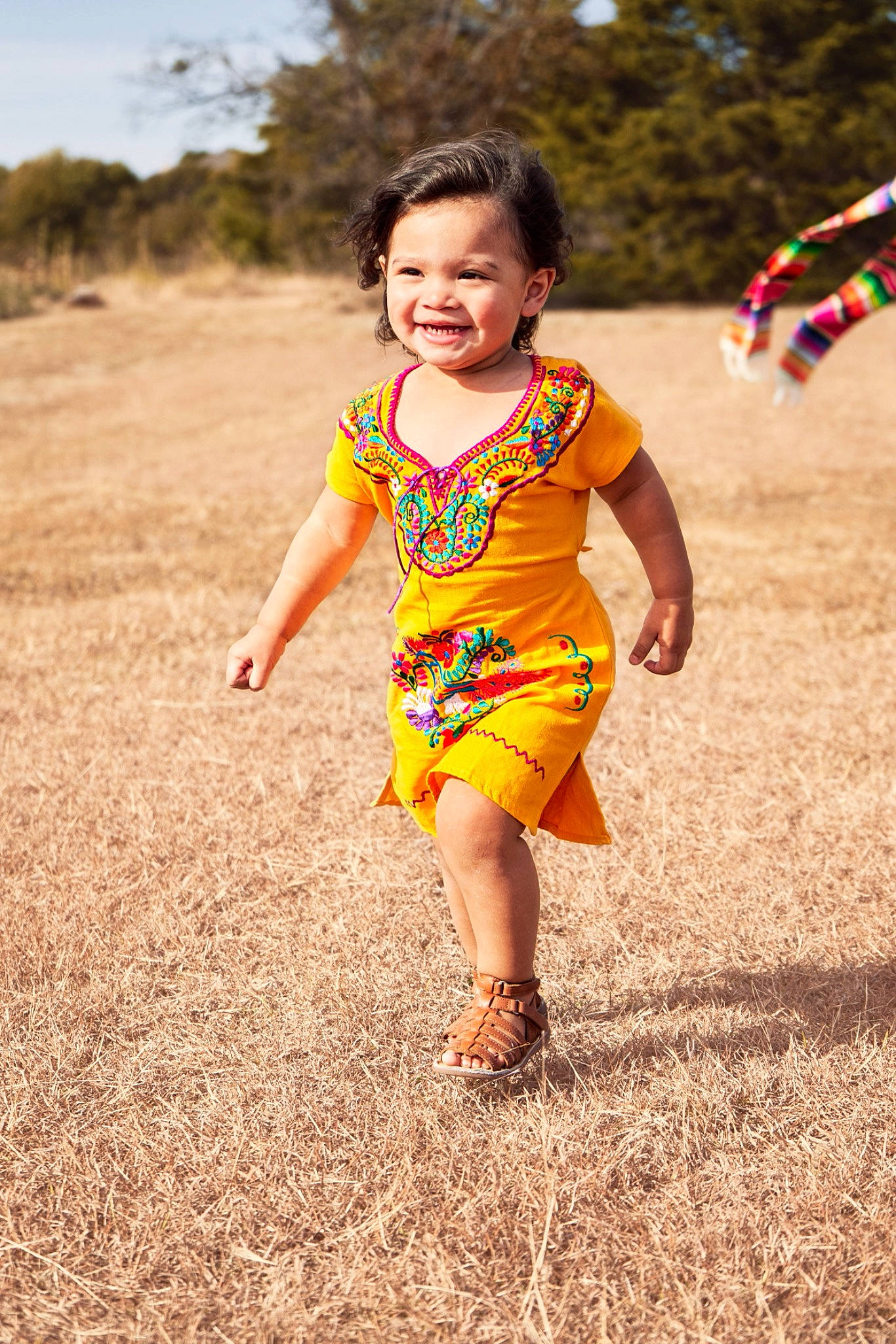 Arielle is registered to the contest to win money with this photo: baby, baby_toddler_clothing, child, face, fun, grass, grassland, happy, human_leg, leisure, magenta, people_in_nature, person, recreation, sandal, skin, sky, smile, t_shirt, toddler