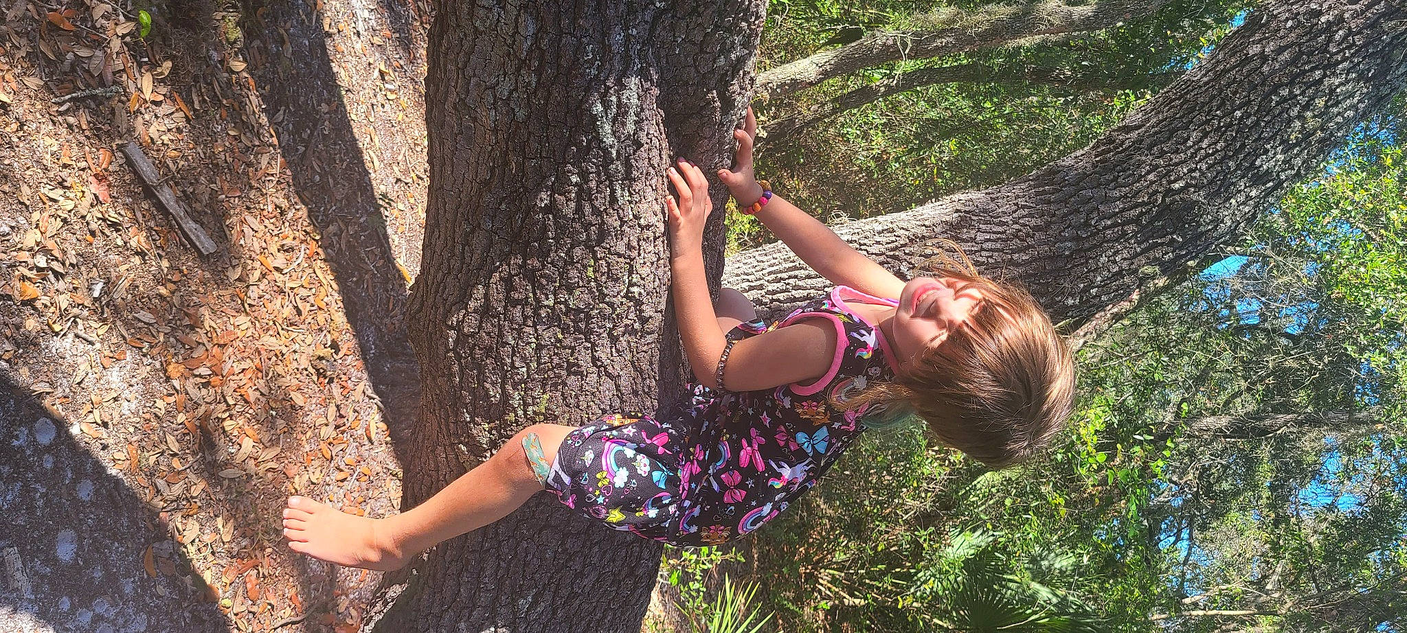 Savana is registered to the contest to win money with this photo: arm, beauty, branch, forest, fun, grass, happy, human_leg, leisure, long_hair, nature, organism, people_in_nature, person, plant, recreation, thigh, tree, trunk, wood