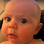 Adeline joined the competition — help win amazing prizes! baby, close_up, face, expression, drool, indoor, child, skin, head, wide_eyes, portrait, young_child, cute, infant, person, human, cheeks, mouth, nose, ear
