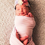 Emma participe au concours pour gagner de l'argent avec cette photo : newborn, baby, swaddled, pink_blanket, flower_headband, sleeping, smiling, infant, cozy, soft_texture, cute, resting, peaceful, portrait, child, wrapped, small_feet, headwear, indoor, closeup