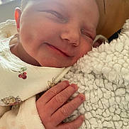 Aurora is registered to the contest to win money with this photo: newborn, baby, smile, sleeping, hand, blanket, soft, closeup, infant, peaceful, cute, skin, cozy, child, portrait, warm, clothing, texture, face, comfort