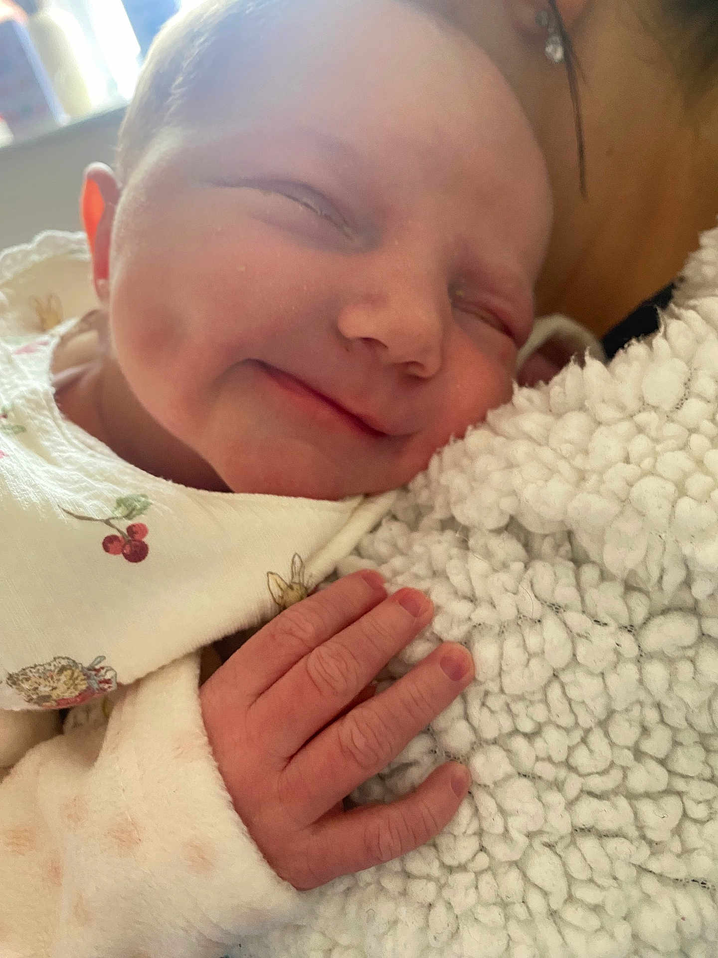 Aurora is registered to the contest to win money with this photo: newborn, baby, smile, sleeping, hand, blanket, soft, closeup, infant, peaceful, cute, skin, cozy, child, portrait, warm, clothing, texture, face, comfort