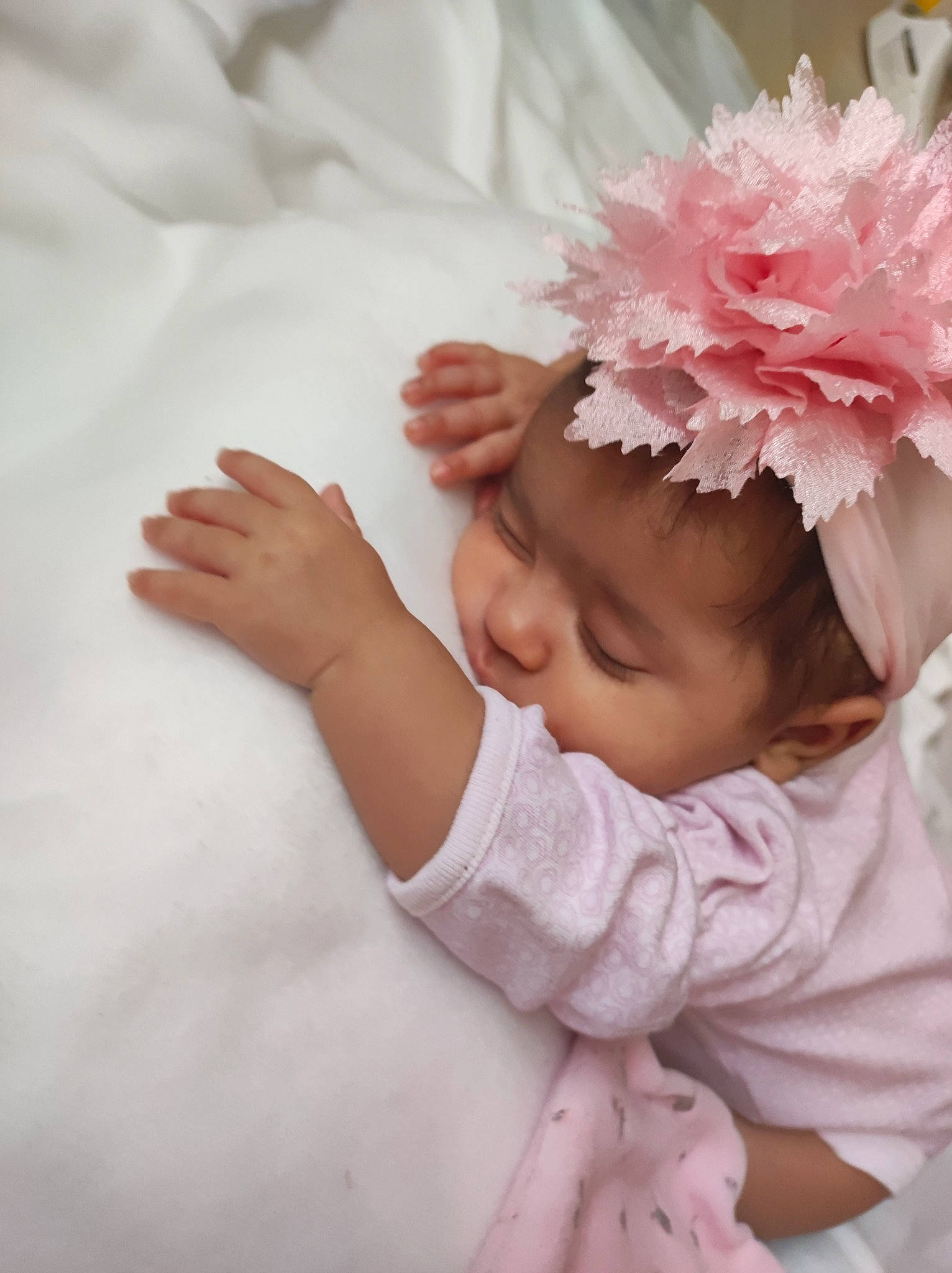 Yamina participe au concours pour gagner de l'argent avec cette photo : baby, baby_toddler_clothing, cheek, comfort, finger, gesture, hair, hand, happy, head, headgear, headpiece, lip, nail, person, petal, pink, skin, sleeve, textile