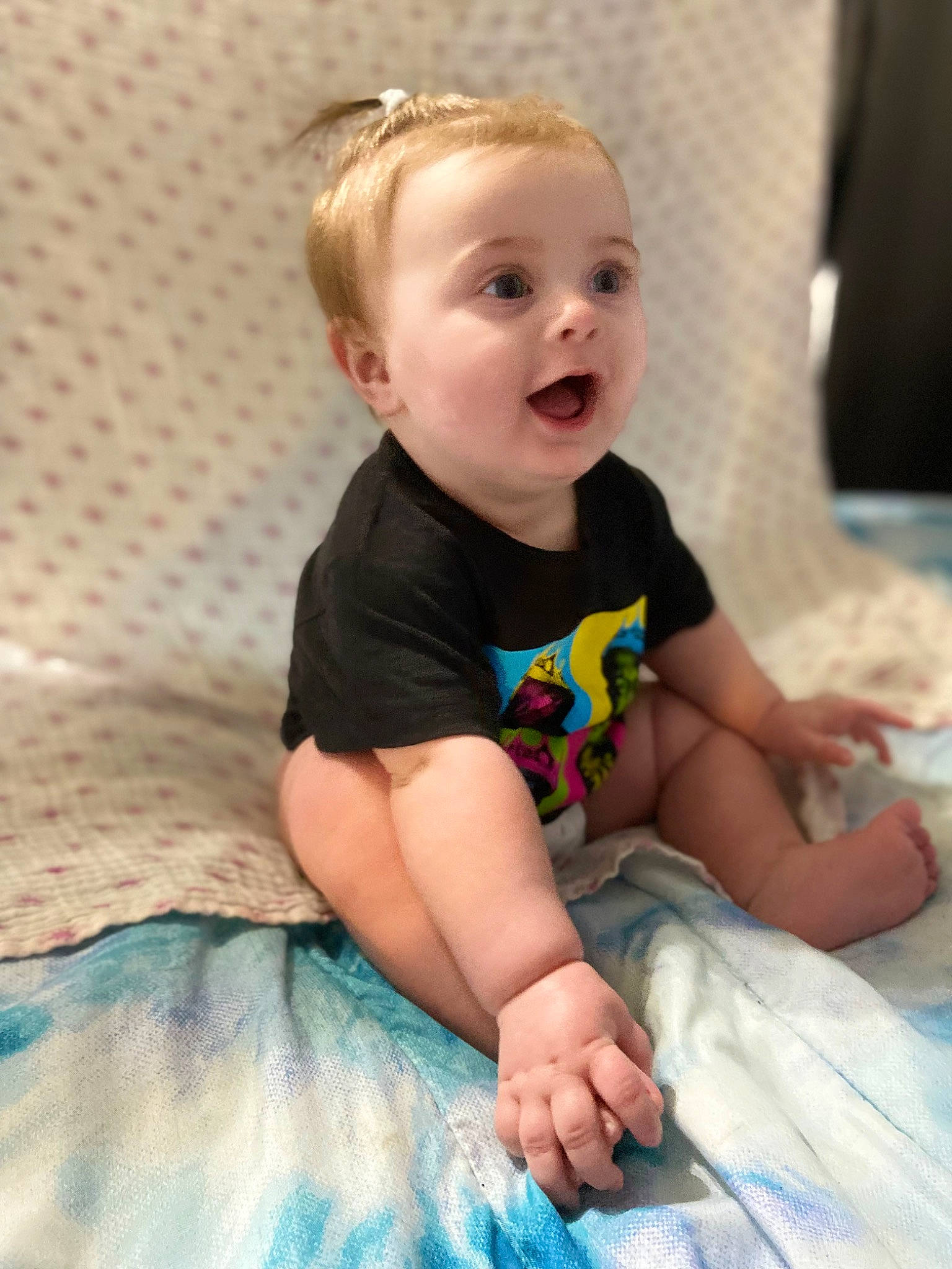 Everleigh is registered to the contest to win money with this photo: baby, baby_toddler_clothing, blond, cheek, child, comfort, eye, face, finger, flash_photography, fun, hair, happy, head, iris, person, sitting, skin, sleeve, smile