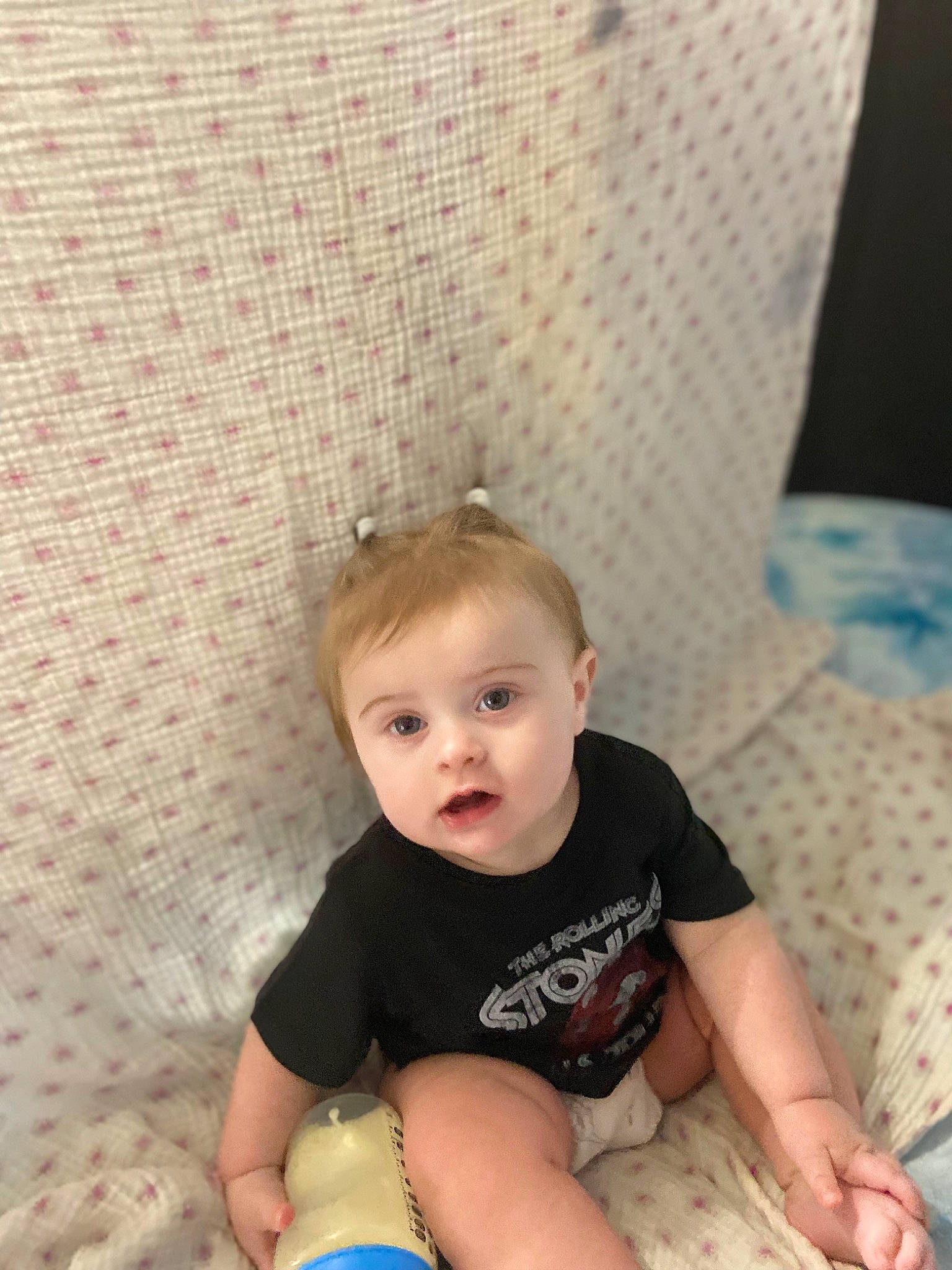 Everleigh is registered to the contest to win money with this photo: baby, baby_toddler_clothing, child, comfort, couch, flooring, foot, fun, human_leg, knee, leisure, person, room, shorts, sitting, skin, sleeve, t_shirt, thigh, toddler