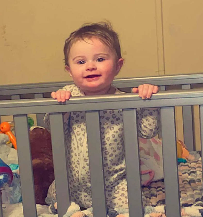 Everleigh is registered to the contest to win money with this photo: baby, baby_products, baby_safety, baby_toddler_clothing, cheek, cradle, eye, facial_expression, fence, finger, happy, human_body, infant_bed, iris, joy, nursery, person, pink, skin, sleeve