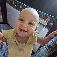 Nyx is registered to the contest to win money with this photo: baby, smiling, child, playpen, yellow_clothing, happy, portrait, indoors, infant, cute, person, face, tooth, hand, mesh, fabric, furniture, daylight, skin, baby_girl