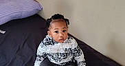 Panthir joined the competition — help win amazing prizes! toddler, child, baby, bed, pillow, clothing, hoodie, pants, socks, hair, braids, face, skin, indoor, room, wall, curious, sitting, young, person