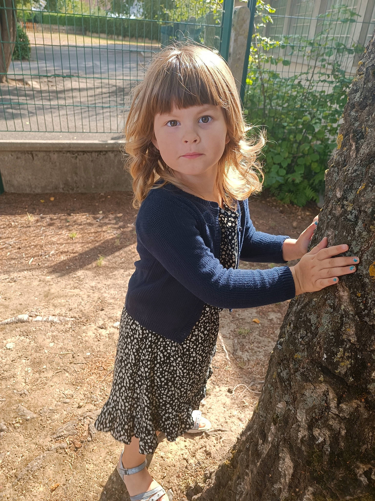 élise participe au concours pour gagner de l'argent avec cette photo : blond, brown_hair, child, eye, fawn, fun, grass, happy, long_hair, people_in_nature, person, shoulder, sitting, sleeve, standing, toddler, tree, trunk, waist, wood