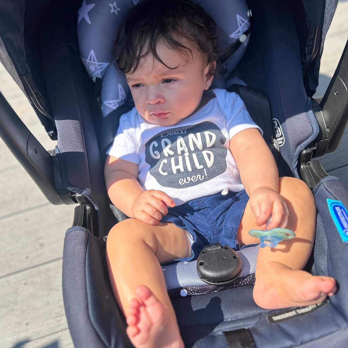 Amylo joined the competition — help win amazing prizes! baby, bare_feet, child, clothing, eyes, face, grandchild, hair, headrest, infant, outdoor, pacifier, pavement, portrait, shirt, shorts, sitting, stars, stroller, sunlight