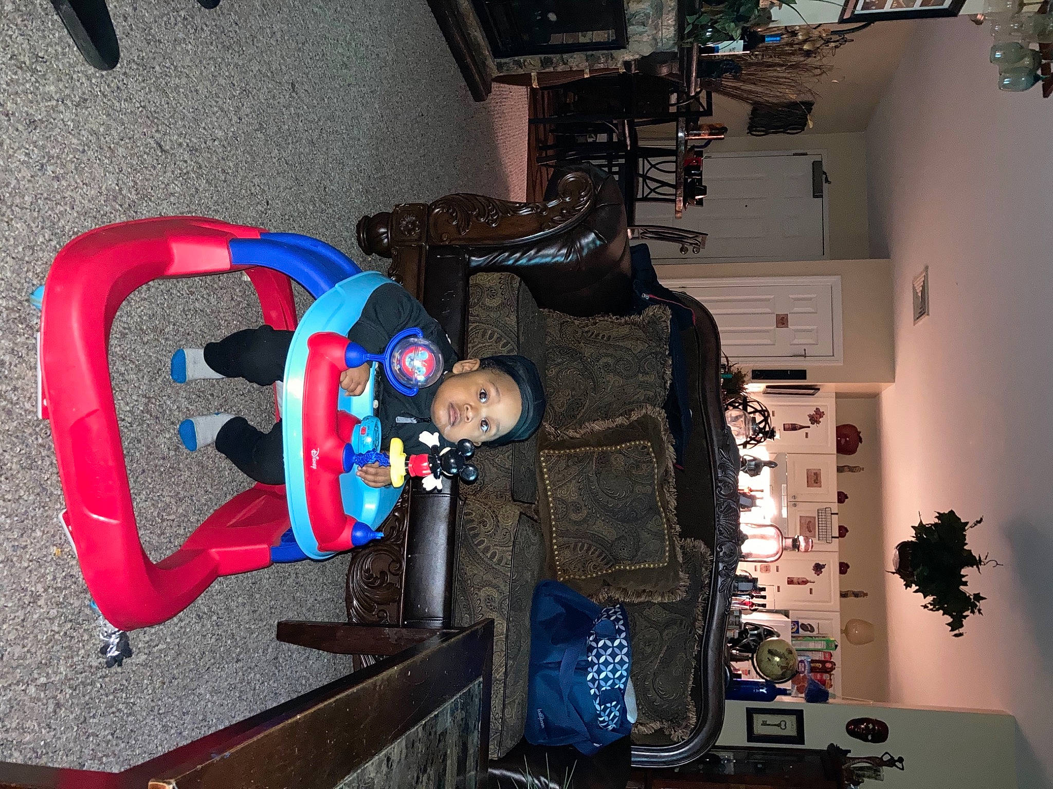 Kyrie is registered to the contest to win money with this photo: automotive_design, bag, carmine, costume, electric_blue, eyewear, fictional_character, fun, helmet, houseplant, luggage_and_bags, machine, person, personal_protective_equipment, plant, room, space, toddler, visual_arts