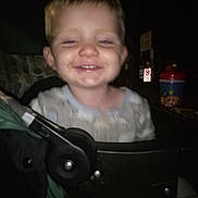 Lucas is registered to the contest to win money with this photo: accessories, baby, bag, clothing, cushion, electronics, face, furniture, handbag, happy, head, homedecor, laughing, person, photography, portrait, smile, strap, stroller, t_shirt