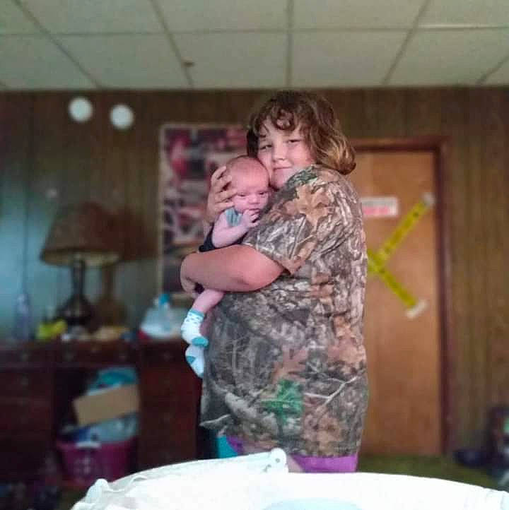 Isabella is registered to the contest to win money with this photo: child, event, fun, happy, hug, joy, lamp, leisure, military_camouflage, party, person, plate, platter, room, t_shirt, tableware, vacation