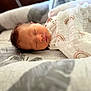 Magnum joined the competition — help win amazing prizes! newborn, baby, sleeping, blanket, bed, patterned_bed, soft_light, peaceful, indoors, infant, wrapped, cozy, portrait, child, rest, cute, human, face, quiet, comfort