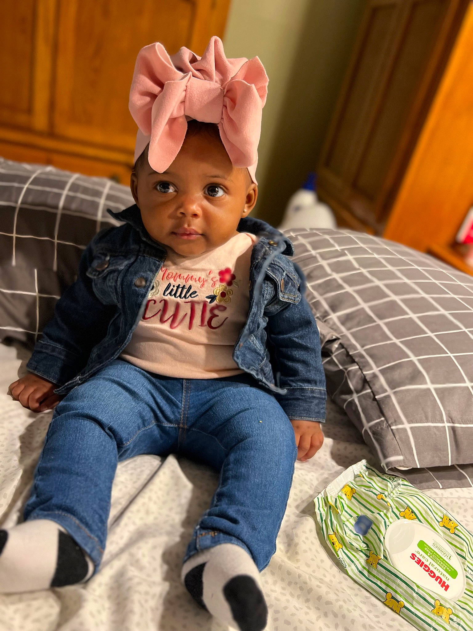 Quinn is registered to the contest to win money with this photo: baby, baby_toddler_clothing, cap, child, comfort, couch, fun, happy, headband, headwear, linens, pattern, person, pillow, plaid, product, room, sitting, sleeve, t_shirt