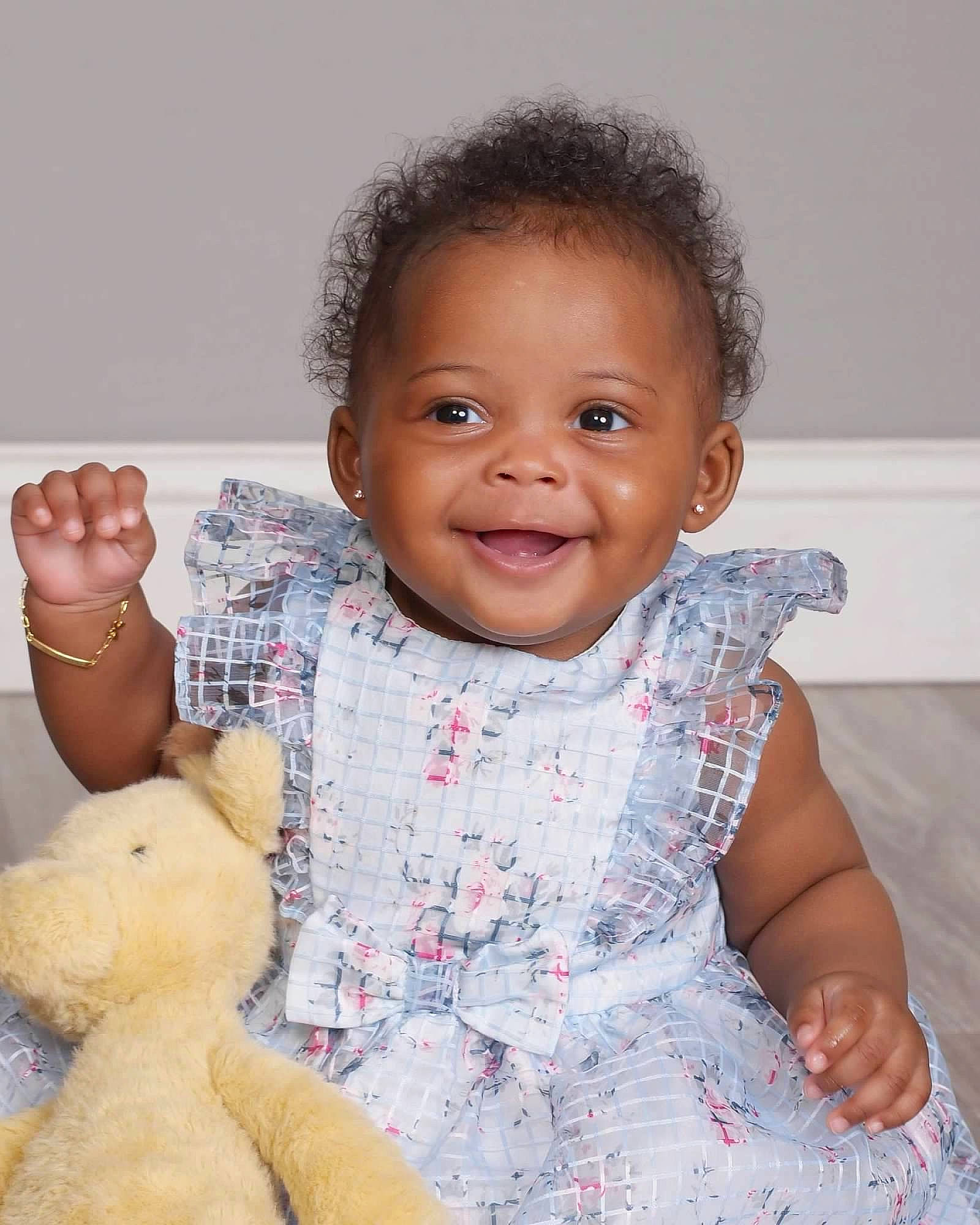 Quinn is registered to the contest to win money with this photo: baby_toddler_clothing, cheek, dress, eye, finger, gesture, hand, happy, iris, joy, nose, organ, person, pink, skin, sleeve, smile, textile, thumb, toddler