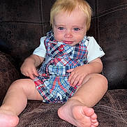 Karson joined the competition — help win amazing prizes! baby, child, infant, portrait, sitting, smiling, blond_hair, blue_eyes, plaid_overalls, anchor, white_shirt, bare_feet, leather_couch, indoor, closeup, front_facing, happy, clothing, family_photo, adorable