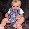 baby, child, infant, portrait, sitting, smiling, blond_hair, blue_eyes, plaid_overalls, anchor, white_shirt, bare_feet, leather_couch, indoor, closeup, front_facing, happy, clothing, family_photo, adorable