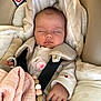 baby, sleeping, car_seat, blanket, pacifier, beads, clothing, child, infant, cute, cozy, safety_harness, indoor, soft_toys, pink, white, hand, face, peaceful, rest