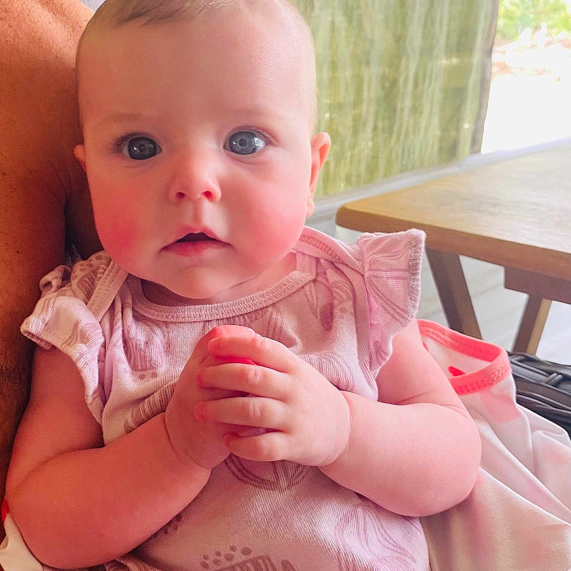 Oakley is registered to the contest to win money with this photo: baby, blanket, blue_eyes, child, closeup, curious_expression, cute, face, hands, head, indoor, infant, person, pink_clothing, portrait, rosy_cheeks, seated, skin, soft_fabric, young