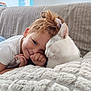 child, cat, couch, blanket, cozy, cute, pet, indoor, smiling, white_cat, toddler, hair, comfort, friendship, soft, relaxed, home, portrait, pacifier, happy