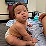 baby, infant, diaper, bed, blanket, indoor, curly_hair, skin, child, person, cute, expression, pout, hand, foot, furniture, television, blanket_texture, home, casual