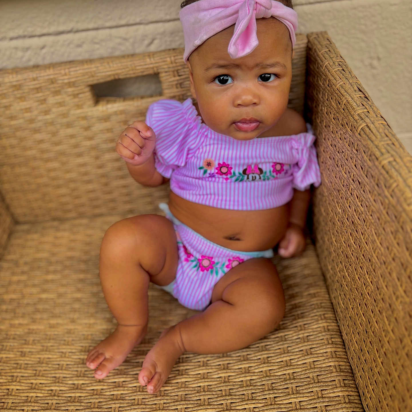 Khyalin joined the competition — help win amazing prizes! baby, barefoot, casual, child, closeup, curious_expression, cute, floral_pattern, furniture, girl, headwear, indoors, infant, pink_clothing, pink_headband, portrait, sitting, skin, woven_chair, young_child