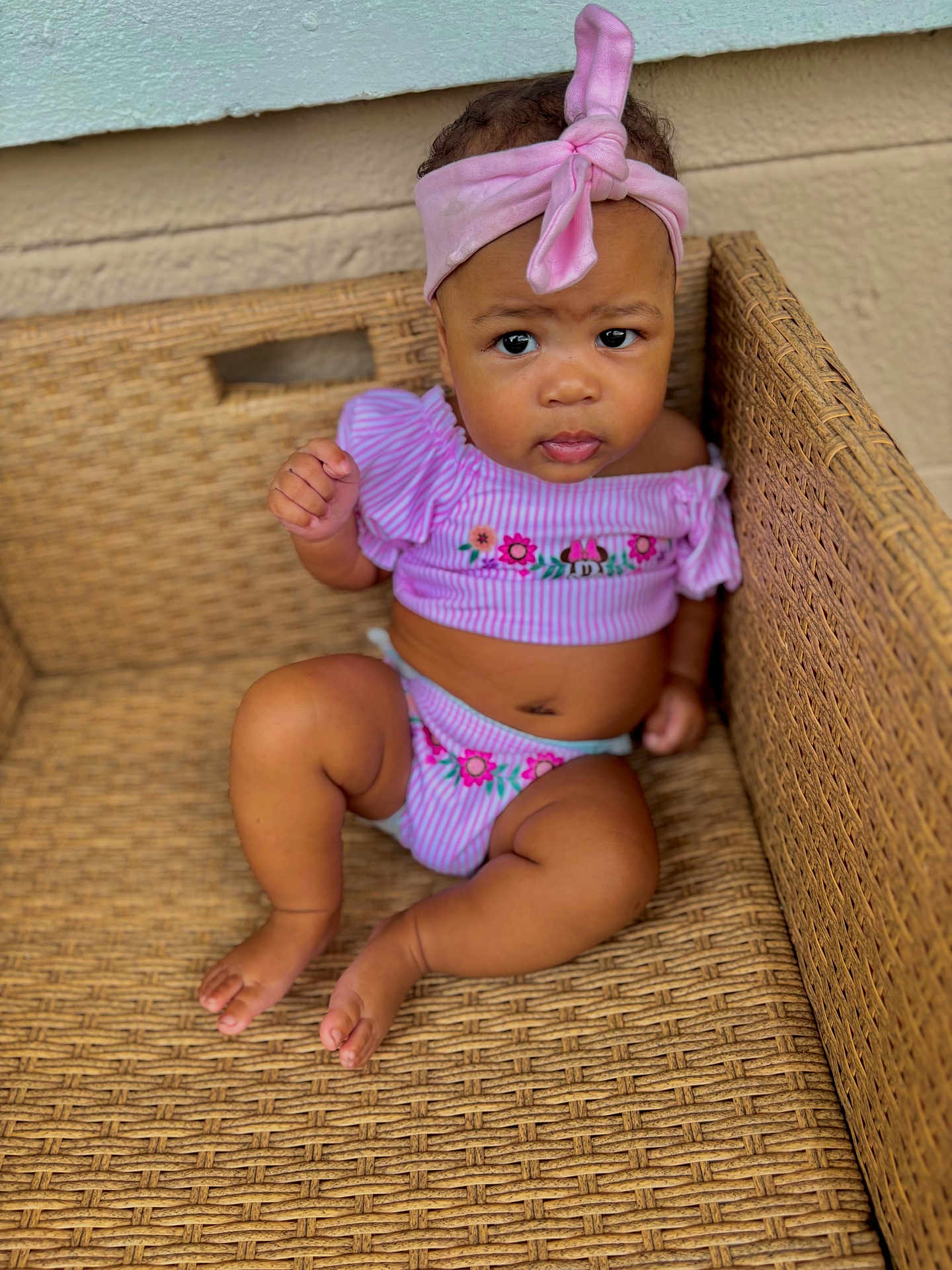 Khyalin joined the competition — help win amazing prizes! baby, barefoot, casual, child, closeup, curious_expression, cute, floral_pattern, furniture, girl, headwear, indoors, infant, pink_clothing, pink_headband, portrait, sitting, skin, woven_chair, young_child