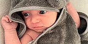Sacha participe au concours pour gagner de l'argent avec cette photo : baby, blanket, child, closeup, curious, cute, ears, elephant, expression, hand, heart, hooded_towel, indoors, infant, person, portrait, skin, soft_texture, towel, wrapped