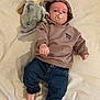 Sacha participe au concours pour gagner de l'argent avec cette photo : baby, bed, blanket, casual_wear, child, clothing, comfort, cute, hoodie, indoor, infant, jeans, lying_down, pacifier, person, plush_toy, portrait, relaxed, soft_toy, young