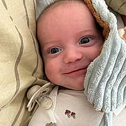 Sacha participe au concours pour gagner de l'argent avec cette photo : adorable, baby, blanket, child, close_up, comfort, cozy, cute, expression, face, head, indoor, infant, lying_down, pacifier, pillow, sleepwear, smile, soft_texture, young