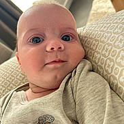 Elio participe au concours pour gagner de l'argent avec cette photo : baby, child, closeup, clothing, cozy, cushion, cute, eyes, face, hedgehog, home, indoor, infant, pattern, person, portrait, relaxing, skin, smile, soft_light