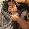 adult, baby, bed, blanket, child, cozy, cute, diaper, family, hands, indoor, infant, person, pigtails, skin, soft_texture, toddler, towel, warm, yellow_shirt