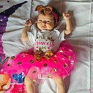 Layla joined the competition — help win amazing prizes! baby, infant, tutu, pink, gold, headband, bows, blanket, floral, stars, cute, lying_down, clothing, person, child, adorable, pattern, colorful, soft, happy