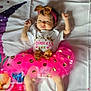 baby, infant, tutu, pink, gold, headband, bows, blanket, floral, stars, cute, lying_down, clothing, person, child, adorable, pattern, colorful, soft, happy