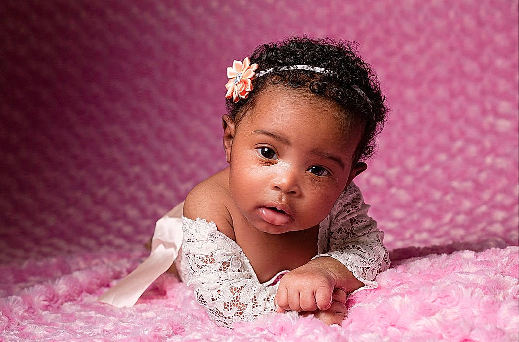 Rayna is registered to the contest to win money with this photo: baby, baby_toddler_clothing, dress, ear, eyelash, finger, flash_photography, hair, happy, headband, headpiece, jewellery, lip, magenta, person, petal, pink, purple, skin, smile