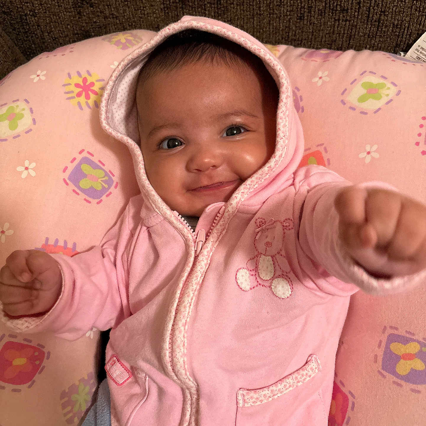 Sovani is registered to the contest to win money with this photo: baby, bodypart, bonnet, clothing, coat, couch, face, finger, hand, hat, head, hood, hoodie, jacket, knitwear, person, photography, portrait, sweater, sweatshirt