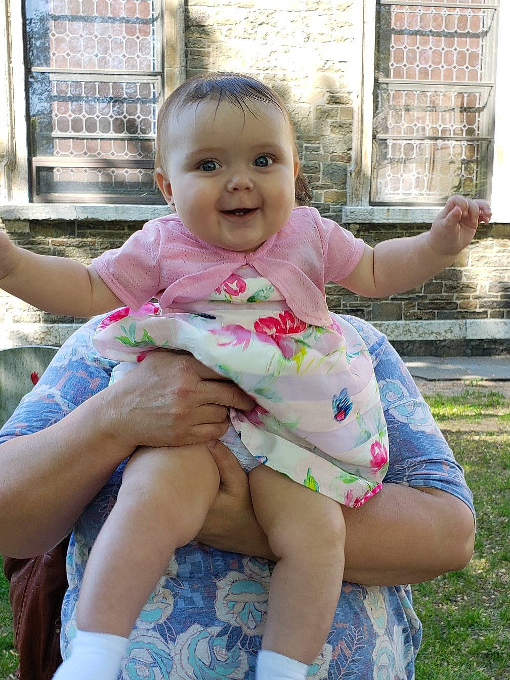 Penelope is registered to the contest to win money with this photo: baby_toddler_clothing, cheek, child, finger, fun, grass, hand, happy, joy, leg, leisure, mammal, people_in_nature, person, pink, plant, skin, smile, summer, thigh