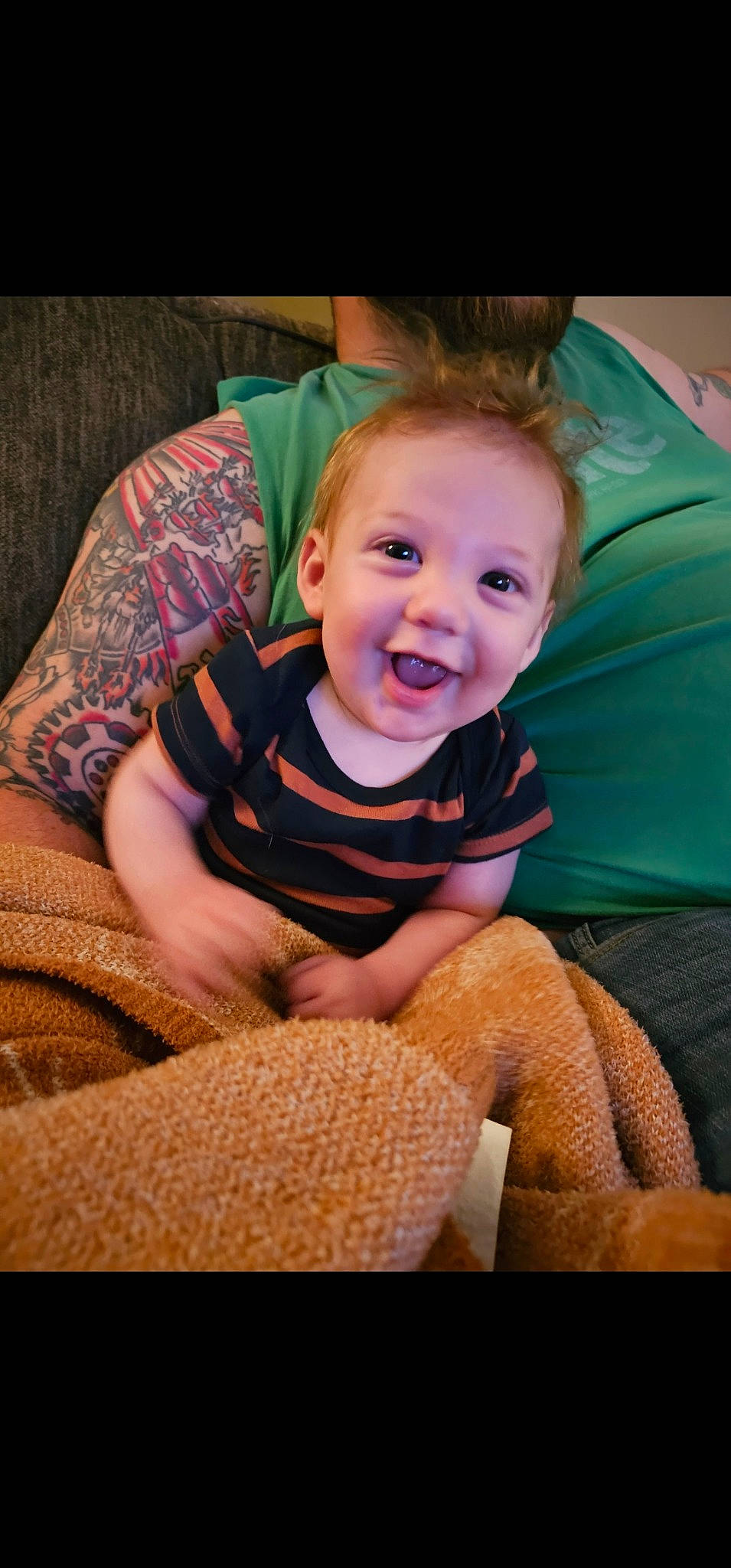 Declan joined the competition — help win amazing prizes! baby, baby_toddler_clothing, cheek, child, comfort, couch, flooring, fun, happy, iris, joy, lap, living_room, mouth, person, room, sitting, sleeve, smile, t_shirt