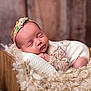 baby, blanket, closeup, cozy, curly_fur, cute, decor, flower, headband, indoor, infant, newborn, peaceful, plant, portrait, resting, sleeping, soft_texture, toddler, wooden_cradle