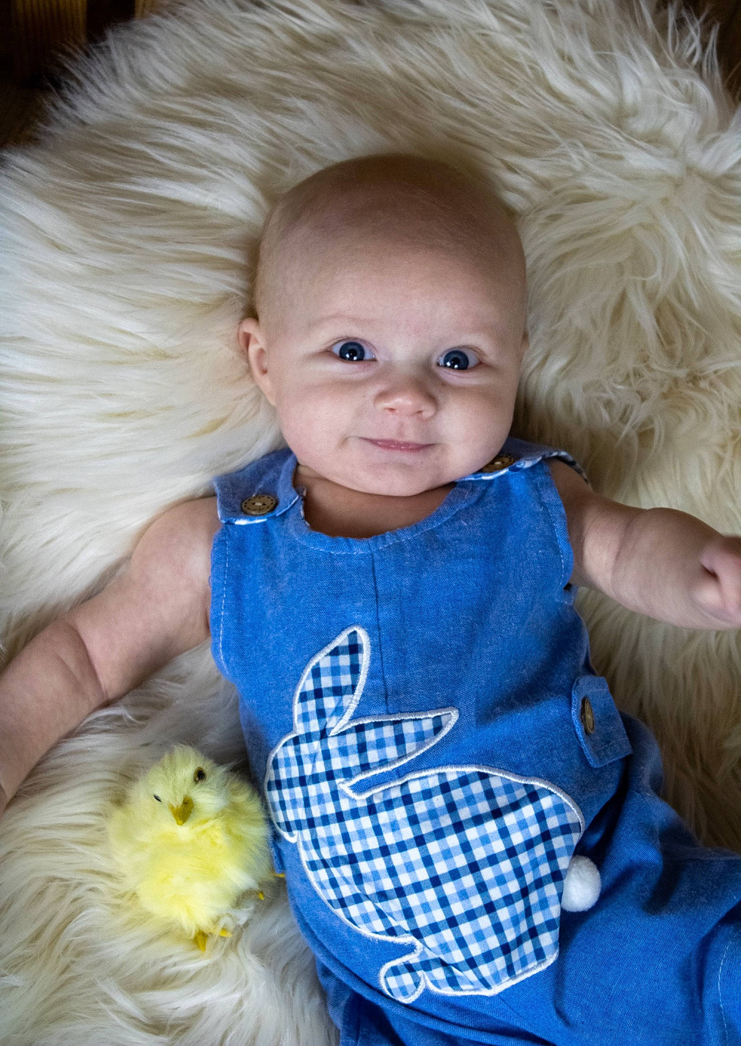 Ledger is registered to the contest to win money with this photo: arm, baby_toddler_clothing, cheek, clothing, eye, face, facial_expression, hair, hand, head, human_body, nose, organ, outerwear, person, product, skin, smile, textile, vertebrate