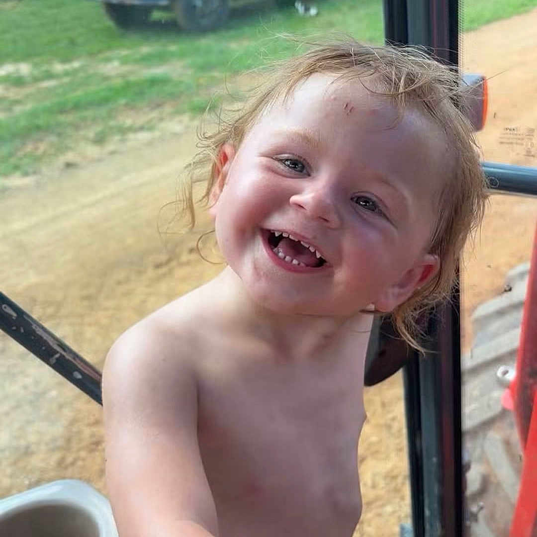Mary joined the competition — help win amazing prizes! child, toddler, smiling, happy, shirtless, hair, hand, face, outdoor, grass, truck, rusty, window, glass, dirt, dirt_road, vehicle, nature, daylight, portrait