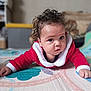 baby, child, close_up, cozy, curious, curls, curly_hair, cute, floor, hands, home, indoor, infant, lying_down, play_mat, portrait, red_clothing, soft_background, white_trim, wide_eyes